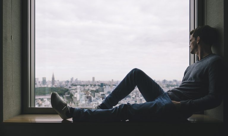 Introspective alone window guy